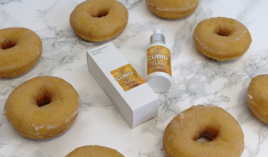 homemade sugar-coated plain doughnuts with CBD oil drops