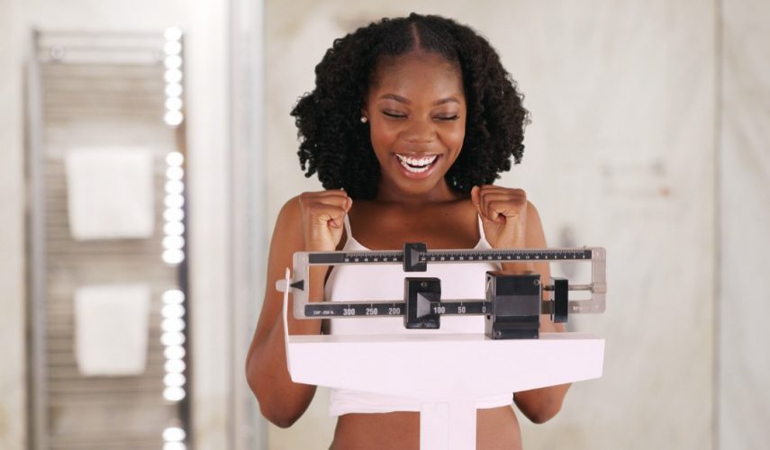 happy women on the weight scales
