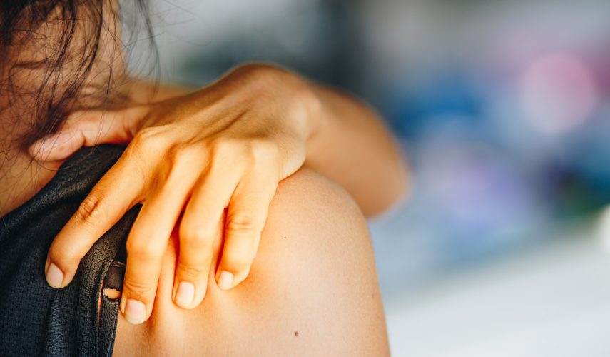 Close up of a young womans shoulder, suffer of pain