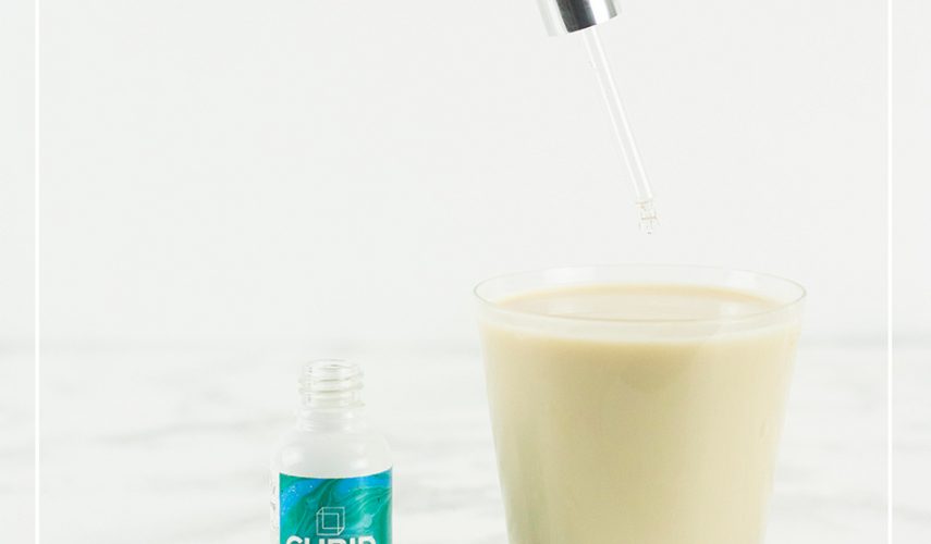 glass of Christmas mocktail fresh Mint Grasshopper with peppermint CBD oil drops