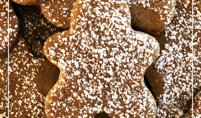freshly baked vegan gingerbread men with frosting on top
