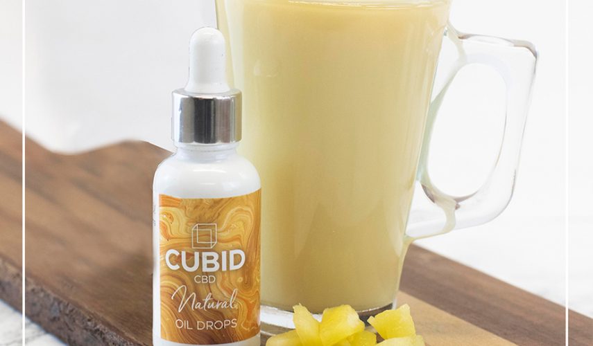 jug of pineapple smoothie with CBD oil drops