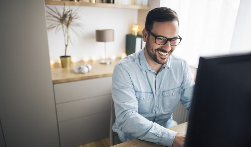 Man using a laptop, working remotely from home