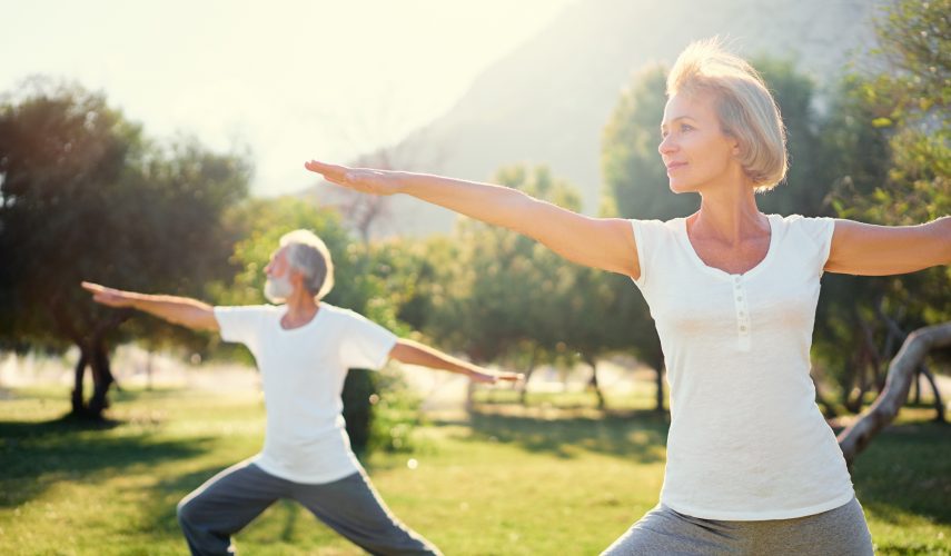two women stretching before a fitness routine in the garden during summer