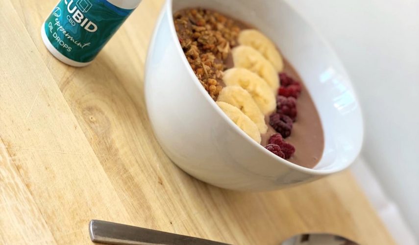 white bowl full of chocolate banana smoothie on a kitchen table