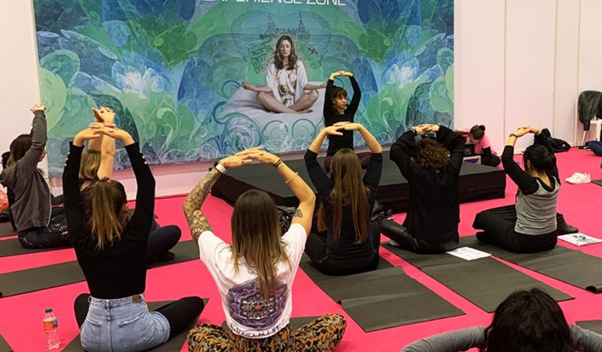 yoga teacher with a class stretching on yoga mats